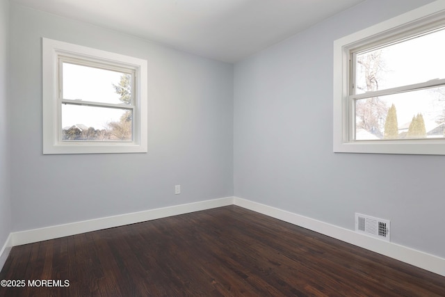 unfurnished room with hardwood / wood-style flooring