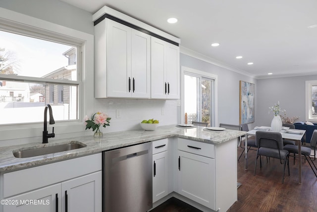 kitchen featuring stainless steel dishwasher, light stone countertops, sink, and white cabinetry