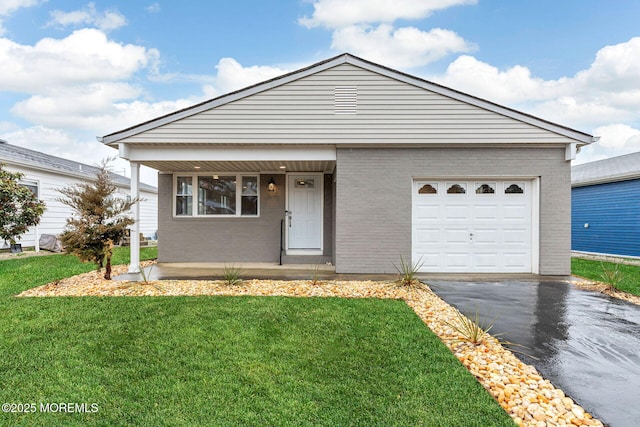 view of front of home featuring a garage, covered porch, and a front lawn