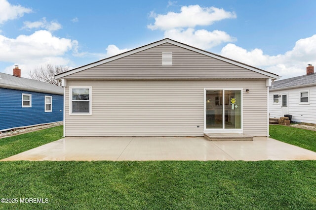 back of property featuring a patio and a yard