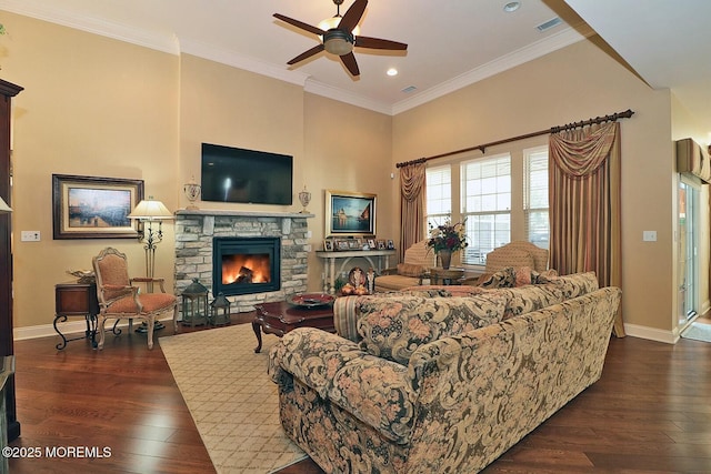 living room with dark hardwood / wood-style flooring, a fireplace, ceiling fan, and ornamental molding