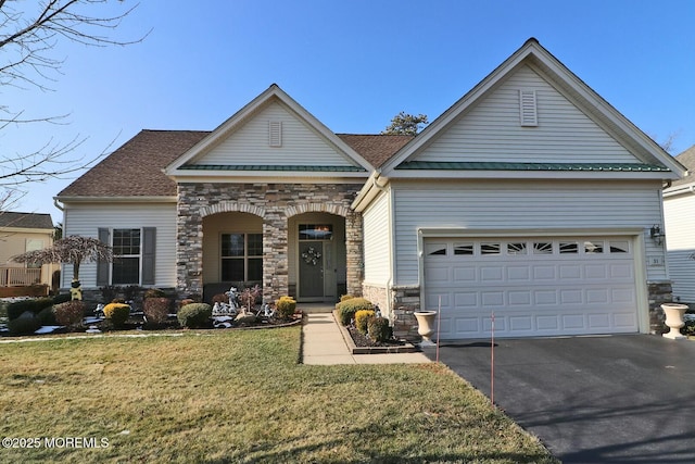 view of front of property with a front lawn and a garage