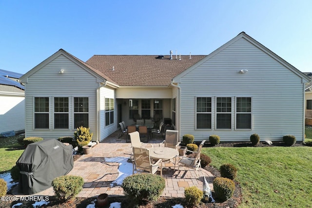 back of house featuring a patio area and a lawn