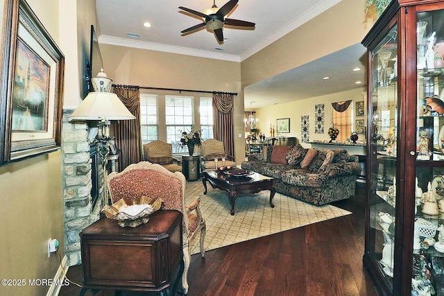 living room with crown molding, ceiling fan with notable chandelier, and wood-type flooring