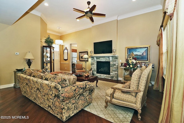 living room featuring a fireplace, ceiling fan, hardwood / wood-style flooring, and ornamental molding