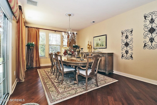 dining space with a chandelier and dark hardwood / wood-style flooring