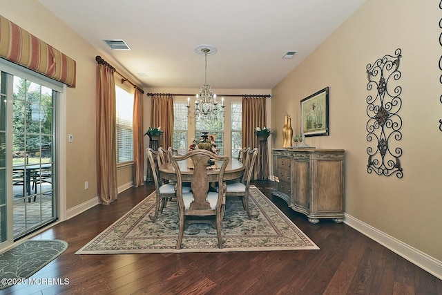 dining space featuring an inviting chandelier and dark wood-type flooring