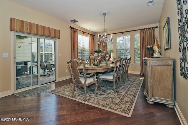 dining area featuring an inviting chandelier and dark hardwood / wood-style floors