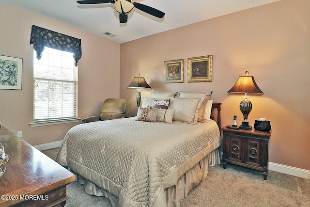 bedroom featuring ceiling fan, light carpet, and multiple windows