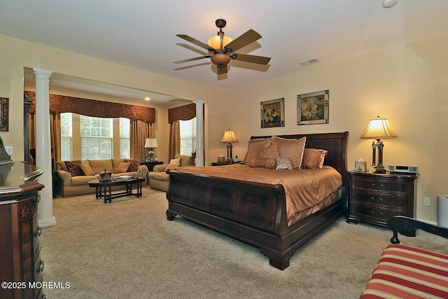 carpeted bedroom featuring decorative columns and ceiling fan