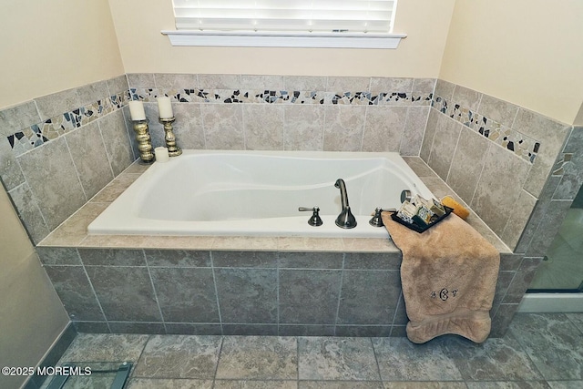 bathroom featuring tiled bath