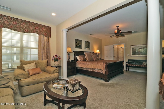 carpeted bedroom featuring a closet, decorative columns, and ceiling fan