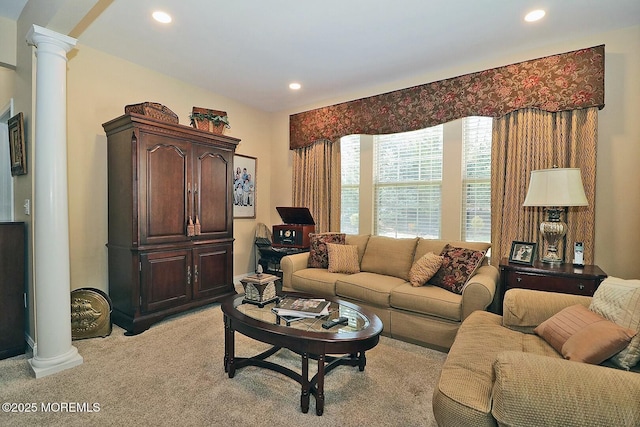 carpeted living room featuring decorative columns