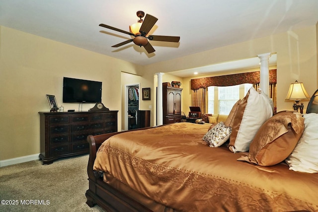 carpeted bedroom with ornate columns, a closet, ceiling fan, and a spacious closet