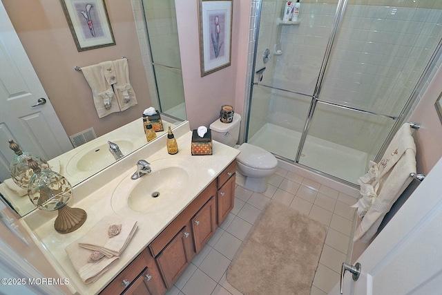 bathroom with toilet, a shower with door, tile patterned flooring, and vanity