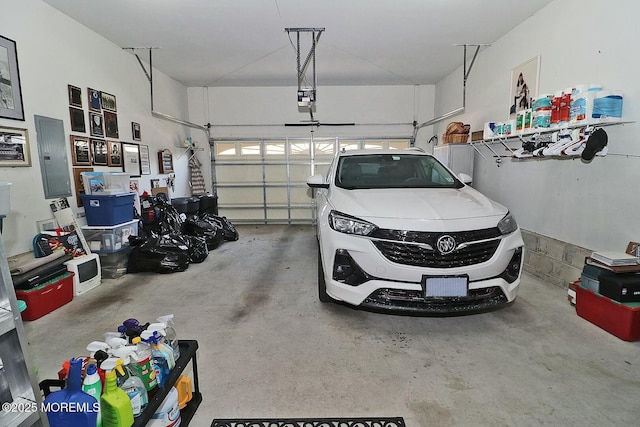 garage featuring electric panel and a garage door opener