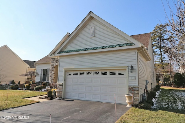 view of front of property with a front lawn and a garage