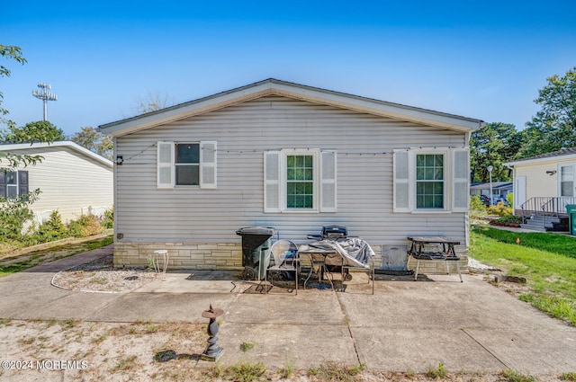 back of property featuring a patio