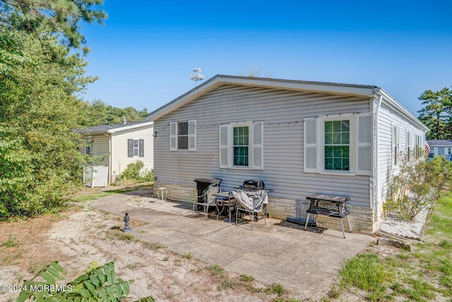 rear view of property featuring a patio