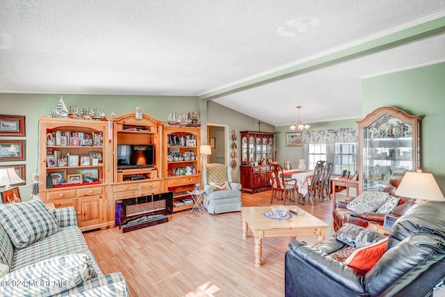 living room with light hardwood / wood-style flooring, lofted ceiling, a textured ceiling, and an inviting chandelier