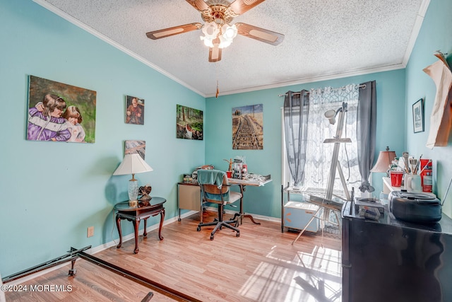 office featuring ceiling fan, crown molding, wood-type flooring, lofted ceiling, and a textured ceiling