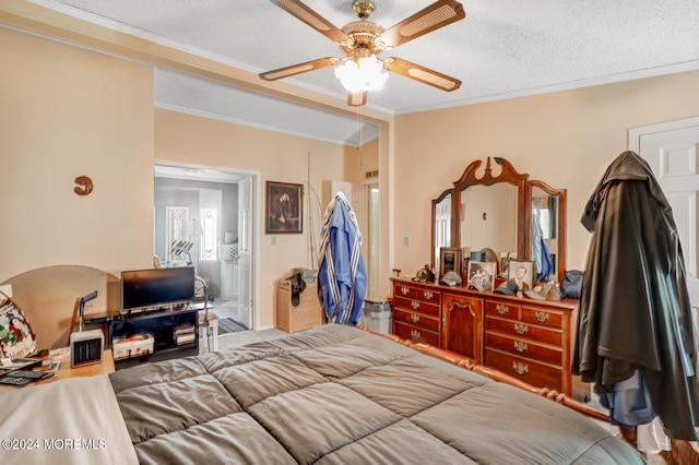 bedroom with a textured ceiling, ceiling fan, and crown molding