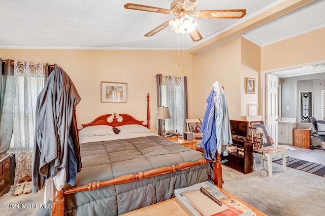 carpeted bedroom featuring a textured ceiling, ceiling fan, and crown molding