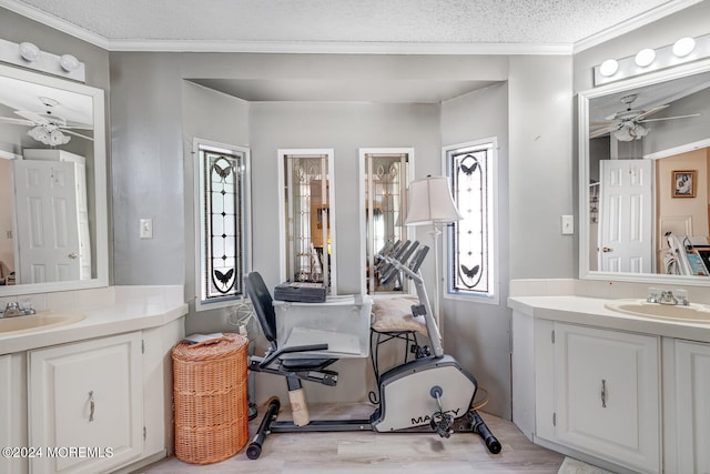 bathroom with ceiling fan, a textured ceiling, and vanity