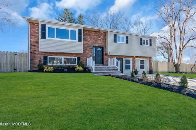 split foyer home with a front lawn