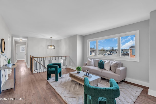 living room featuring a notable chandelier and hardwood / wood-style flooring