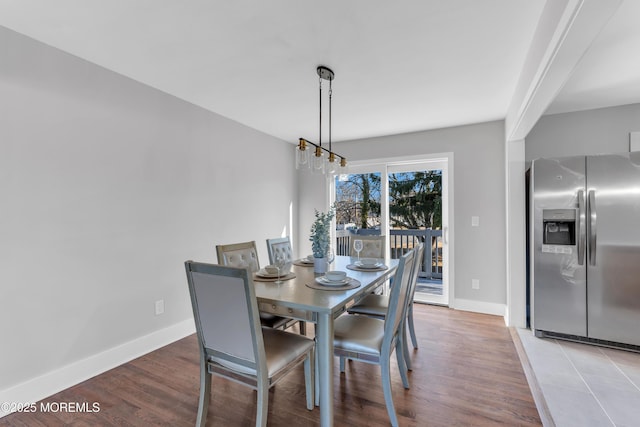 dining space with a notable chandelier and hardwood / wood-style floors