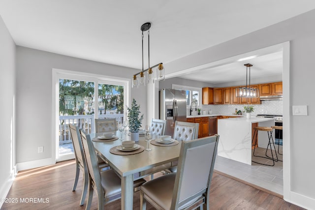 dining space featuring sink and light hardwood / wood-style floors