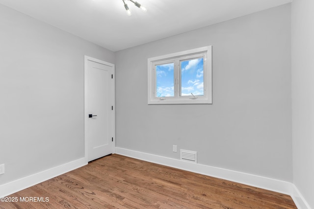 spare room with wood-type flooring