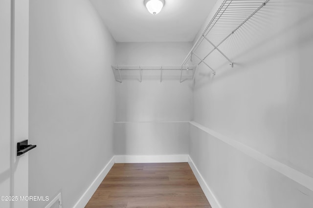 spacious closet featuring hardwood / wood-style flooring