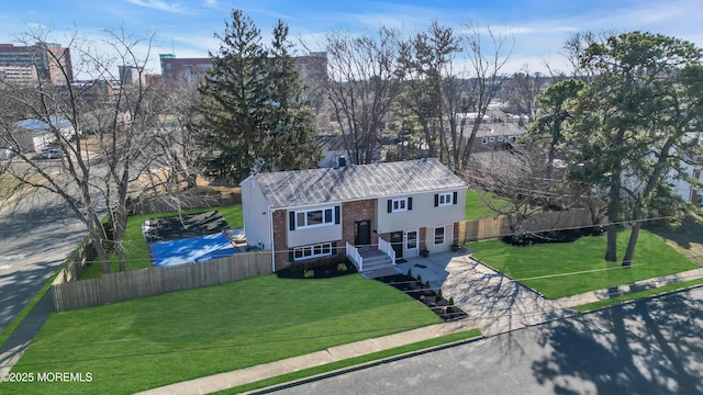 split foyer home with a front lawn