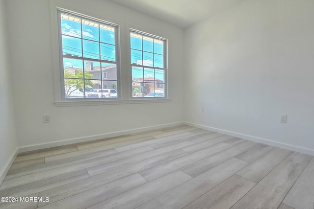 spare room with light hardwood / wood-style floors