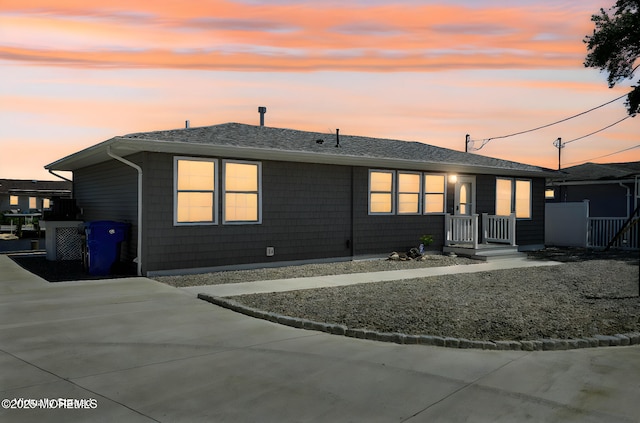 view of back house at dusk