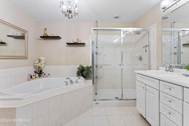 bathroom with tile patterned floors, vanity, a notable chandelier, and shower with separate bathtub