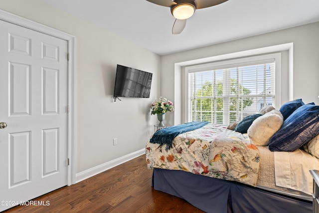 bedroom with ceiling fan and dark wood-type flooring