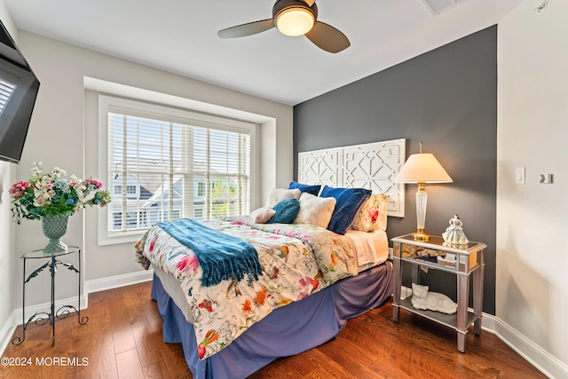 bedroom with ceiling fan and dark wood-type flooring