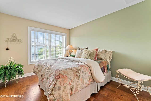 bedroom with dark wood-type flooring and multiple windows