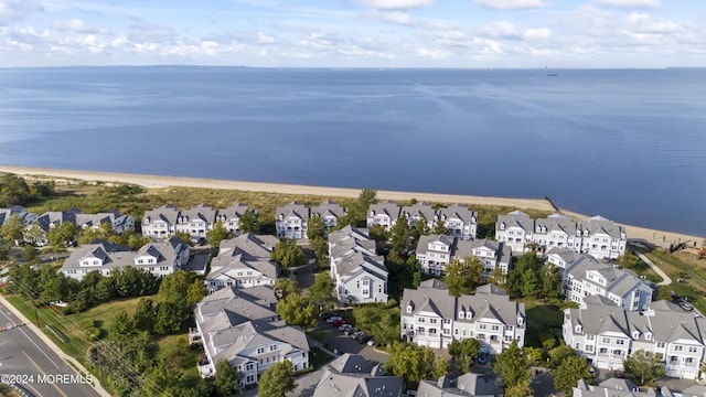 birds eye view of property with a water view and a view of the beach