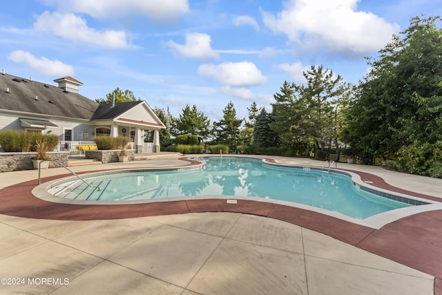 view of swimming pool with a patio