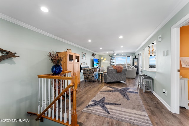 living room featuring hardwood / wood-style flooring and ornamental molding