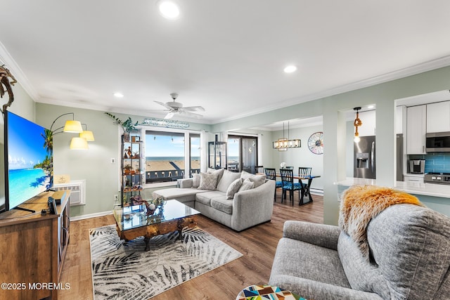 living room with ceiling fan, hardwood / wood-style floors, crown molding, and a wall mounted air conditioner