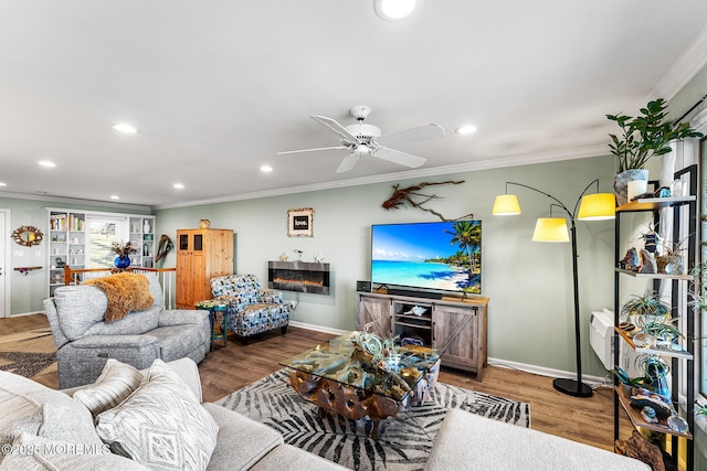 living room featuring hardwood / wood-style flooring, crown molding, and ceiling fan