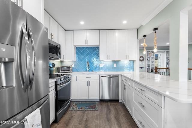 kitchen featuring white cabinetry, kitchen peninsula, and stainless steel appliances