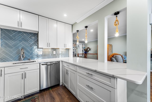 kitchen featuring dishwasher, white cabinetry, decorative backsplash, sink, and kitchen peninsula