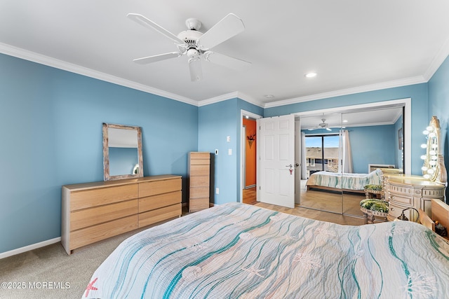 bedroom featuring ceiling fan, crown molding, light colored carpet, and a closet