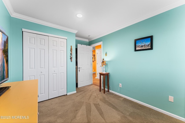 bedroom with a closet, crown molding, and carpet flooring